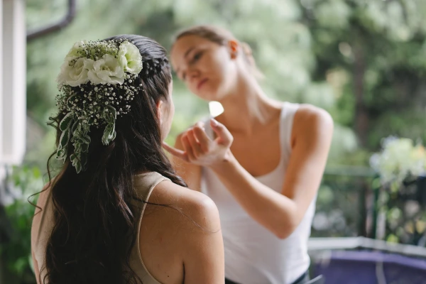 Back view of the bride's hairstyle featuring fresh white flowers and baby's breath.