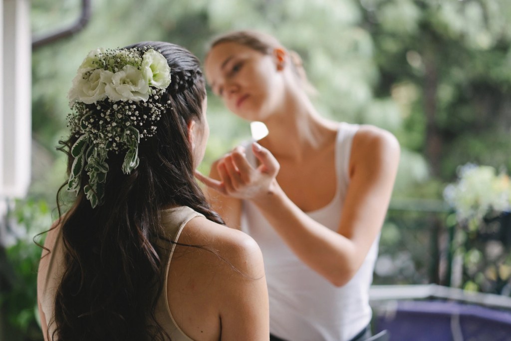 Back view of the bride's hairstyle featuring fresh white flowers and baby's breath.