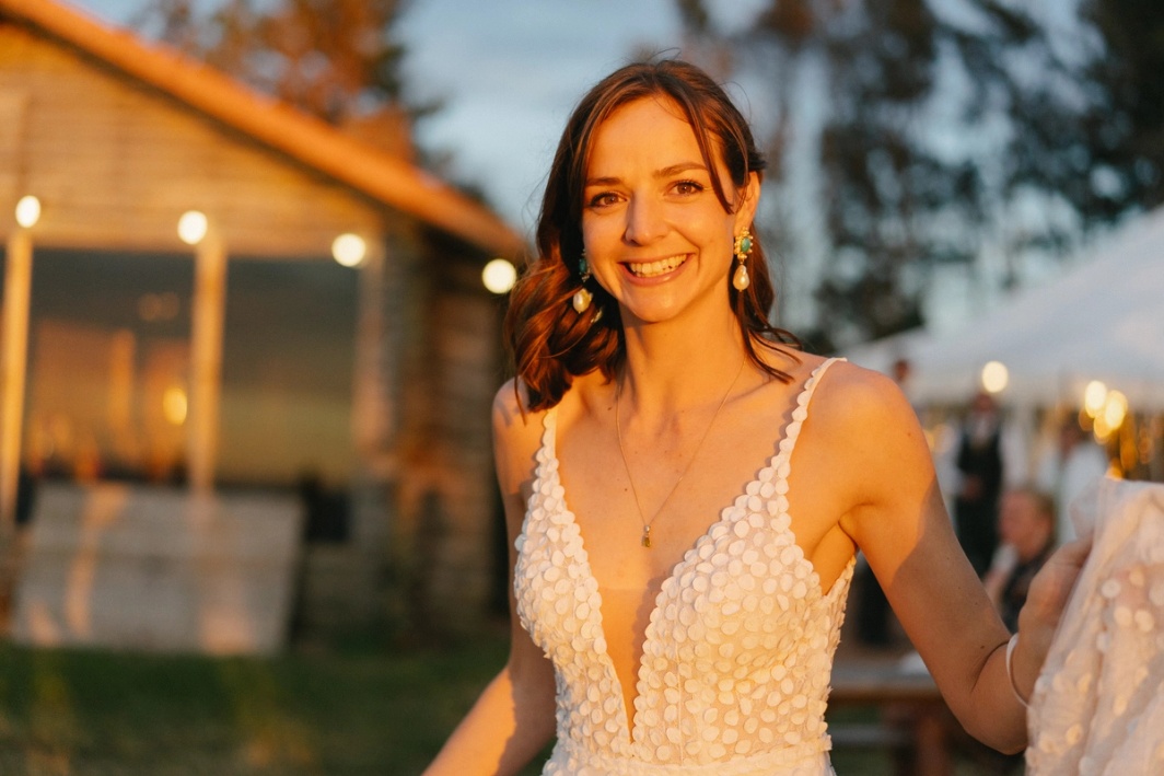 Documentary wedding photography image of bride in golden hour sunset. Services and packages