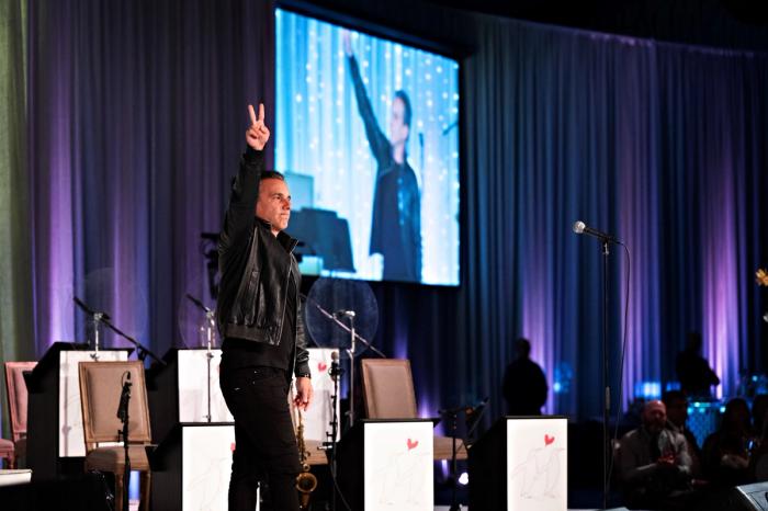 Celebrity comedian, Sebastian Maniscalco, delivering a humorous set to a captivated audience—illustrating the impact of selecting the right entertainment for memorable events .