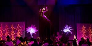 An aerial dancer  performs above a Gatsby themed event.