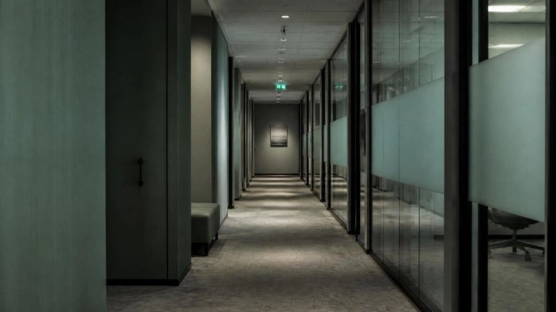 An empty office corridor at the end of the day, representing workplace stress during menopause
