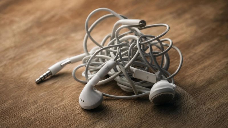 A tangled pair of headphones on a desk, representing the confusion and exhaustion of poor boundaries