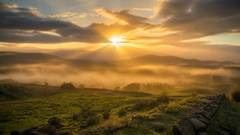 A sunrise over a calm Irish landscape symbolising breaking the cycle of sleep anxiety