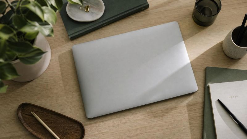 A quiet workspace with a laptop and a notebook, representing mental compulsions happening inside the mind