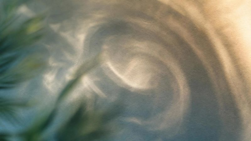 A swirling pattern of light and shadow, representing intrusive thoughts and the OCD cycle