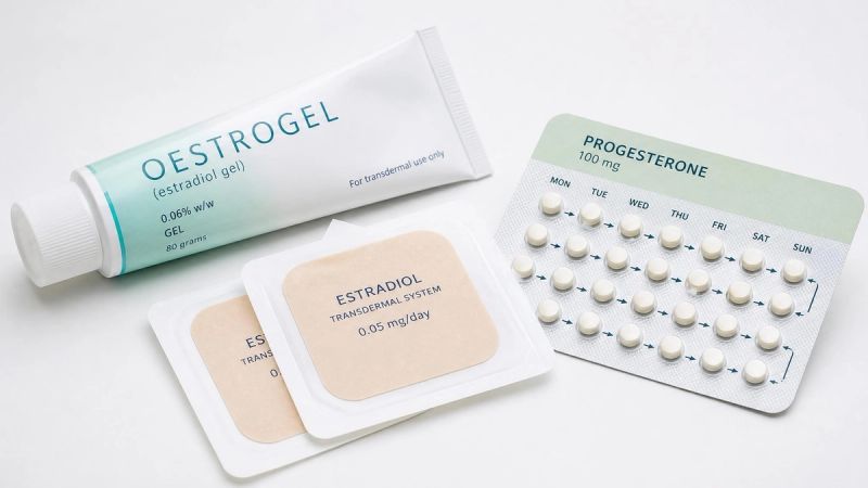 A collection of HRT patches and gel on a clean white surface