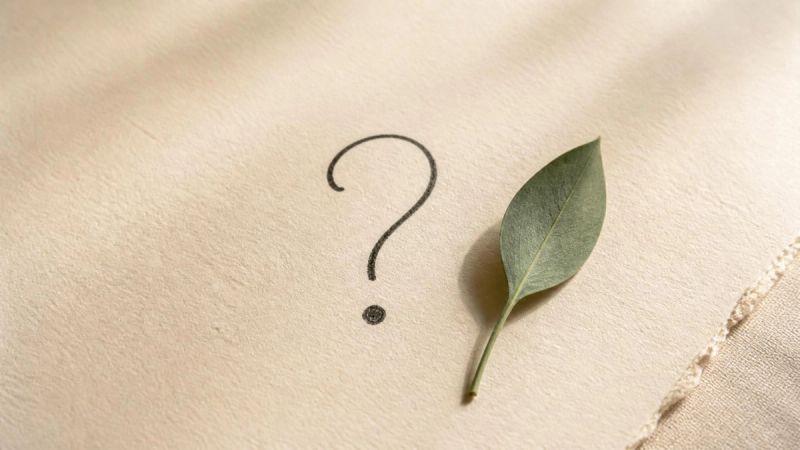 A simple FAQ concept with a handwritten question mark on textured paper