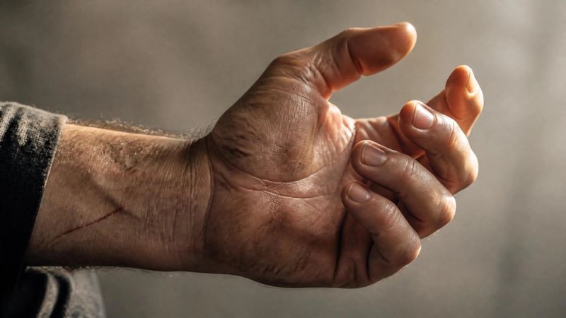 A tightly closed fist gradually relaxing, symbolising the cost of holding anger in