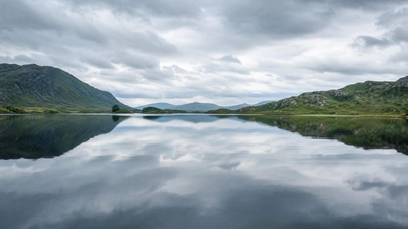 Still water reflecting the sky, symbolising how PTSD affects the mind and body
