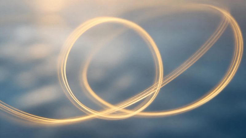 Abstract loops of warm light representing intrusive thoughts and the cycle of OCD