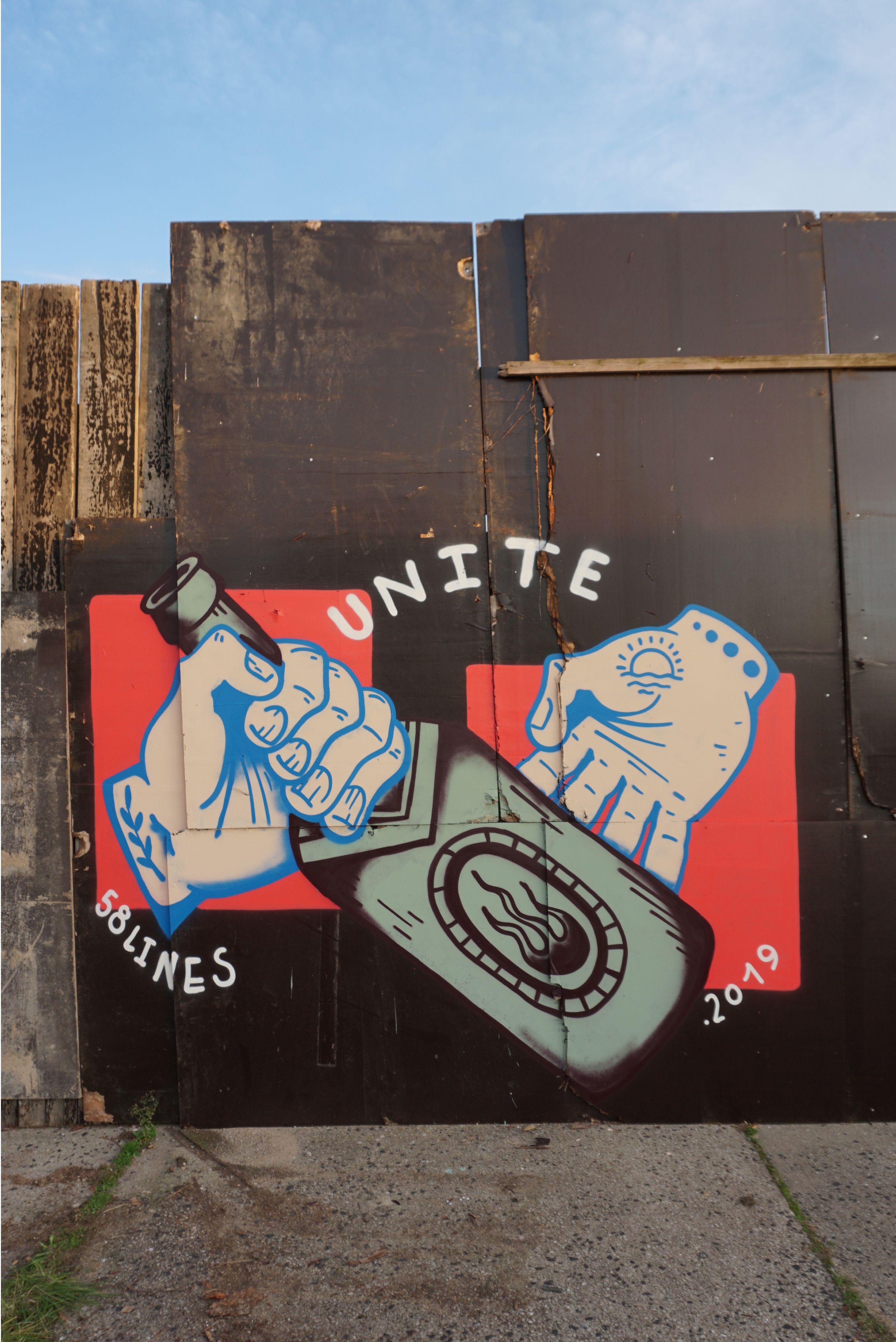 Zusehen ist ein Graffiti, auf welchem zwei Hände und eine Molotovflasche abgebildet sind. 