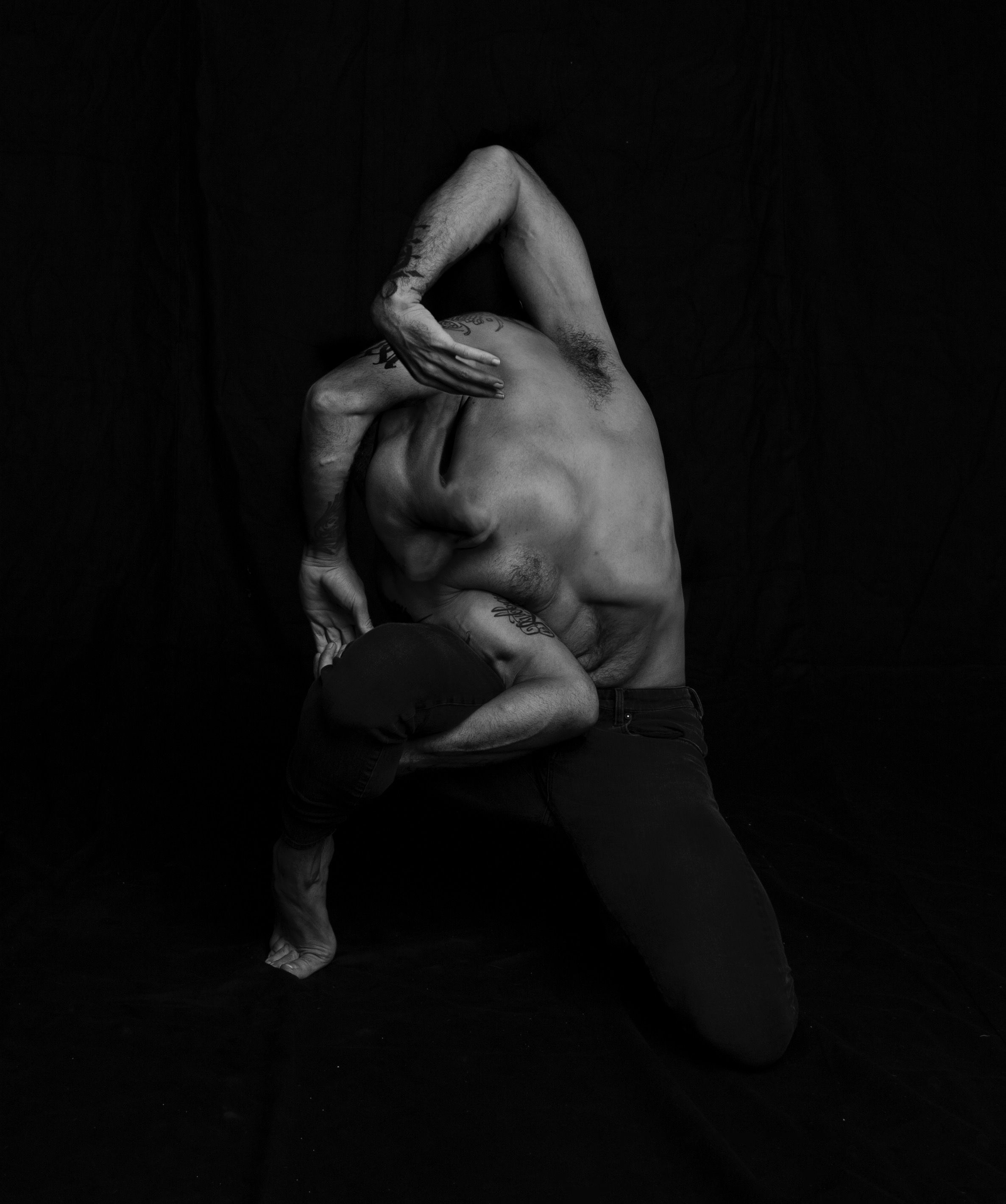 Picture showing a dancer with his arms and legs tied together