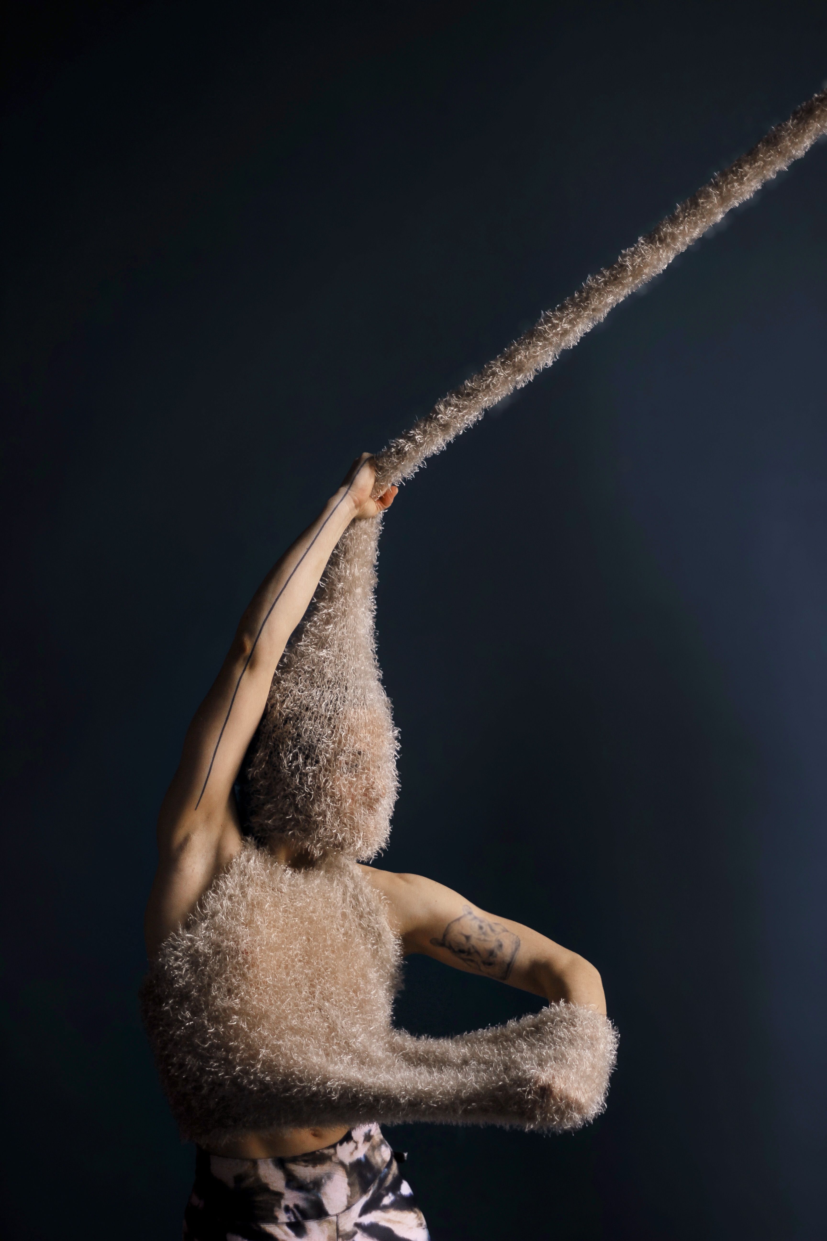 An artist in front of a blue wall