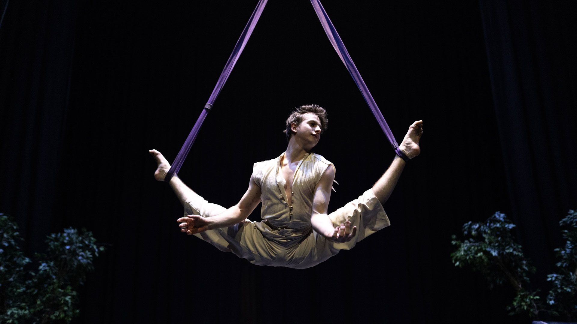 acrobatics, performing an exercise on a rope