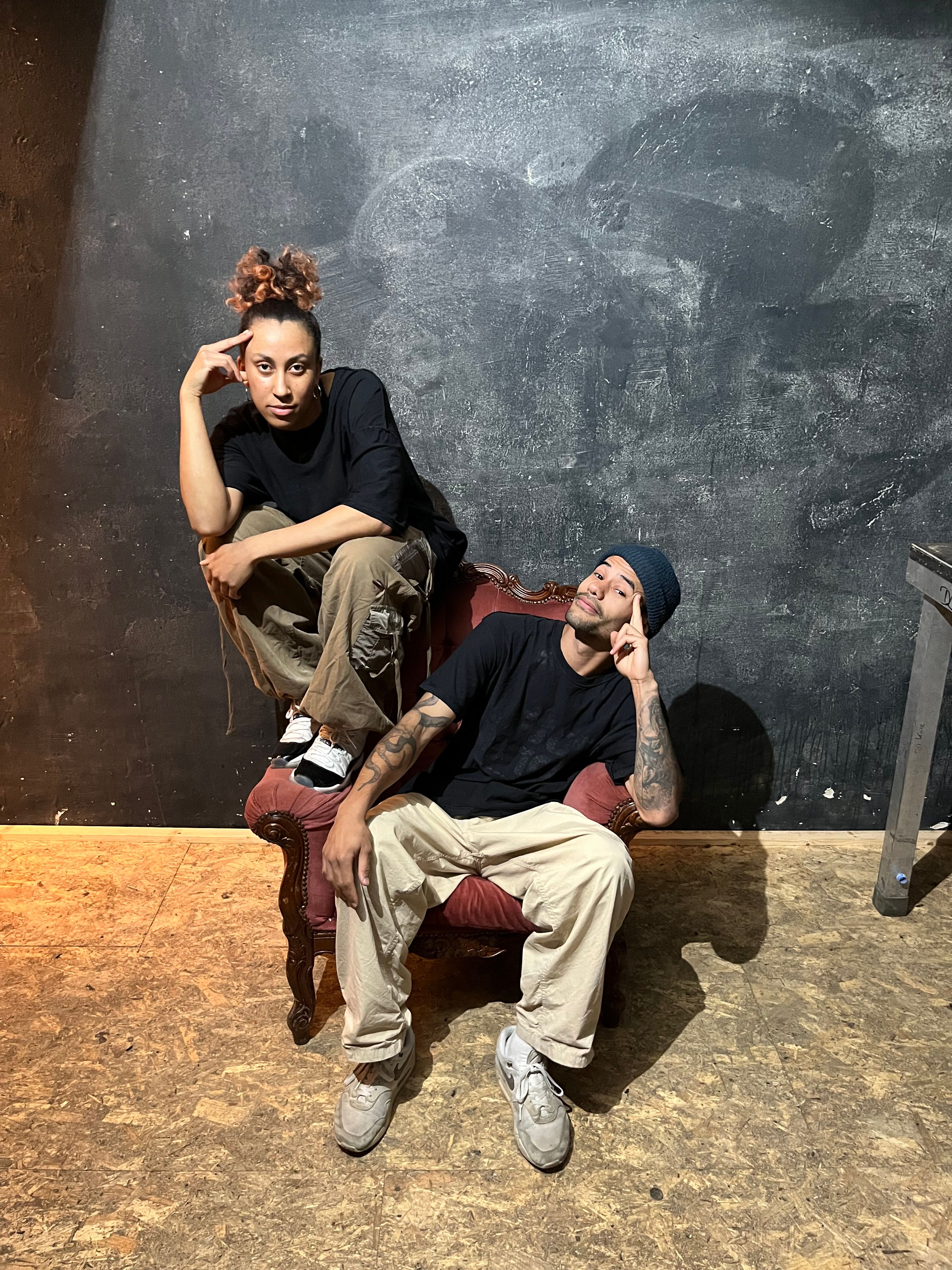 2 dancers sitting on a chair