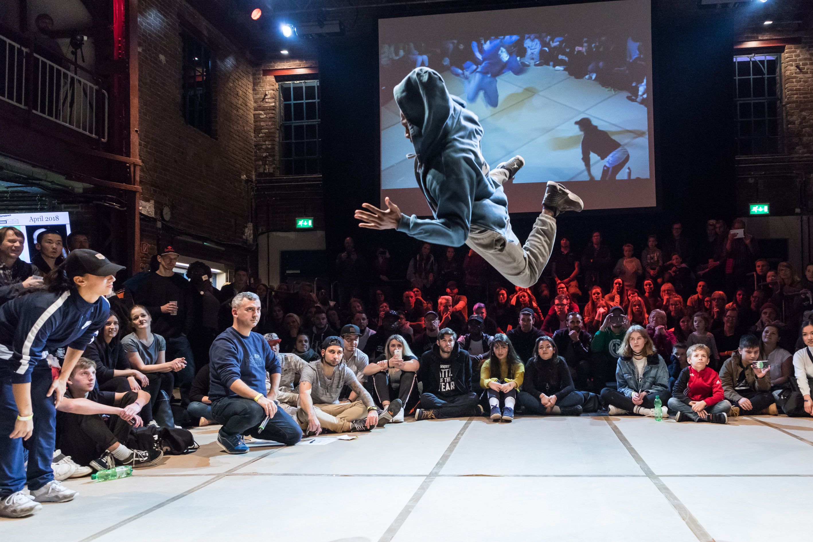 Dancers performing a dance move with another dancer standing next to them