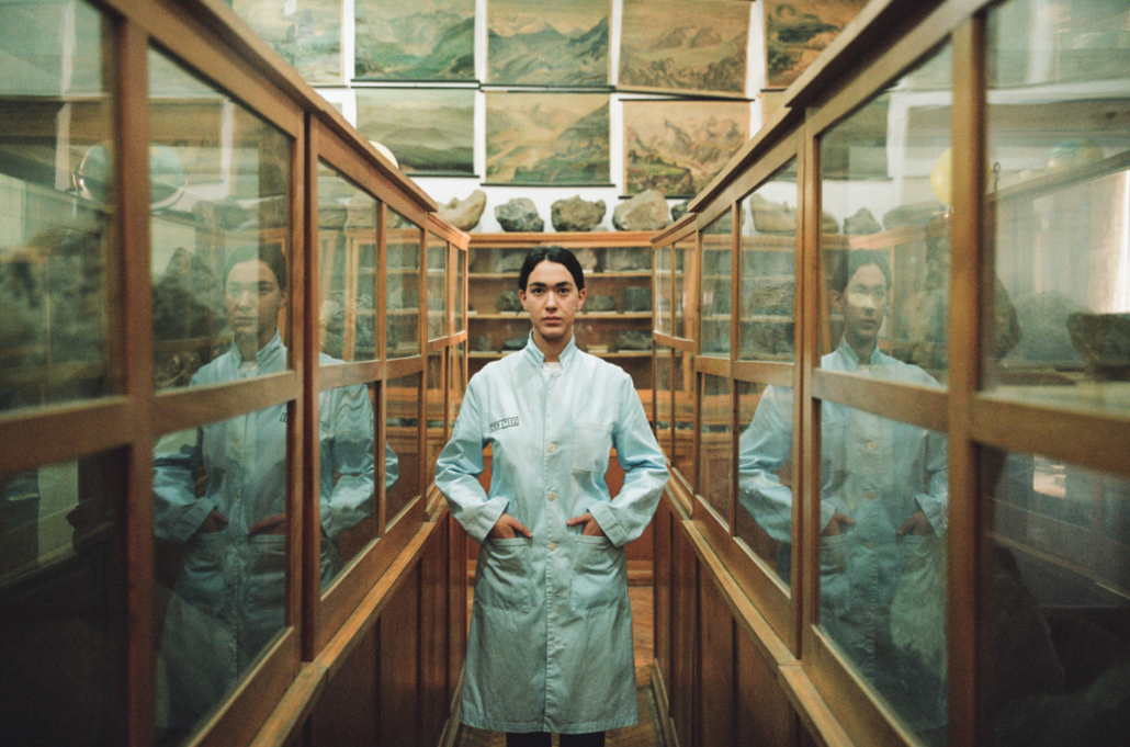 Person standing between display cases in a museum