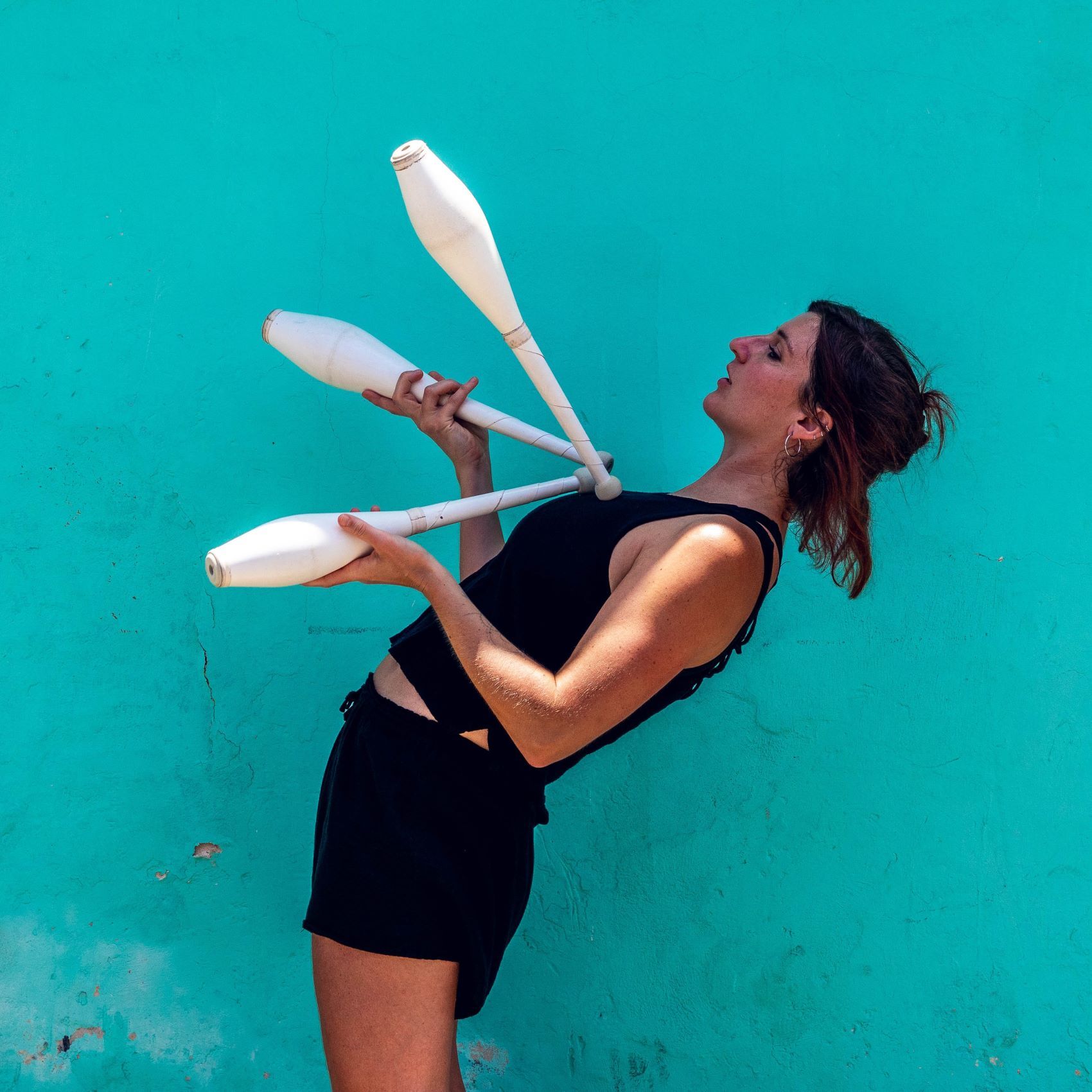 Woman juggling and leaning back