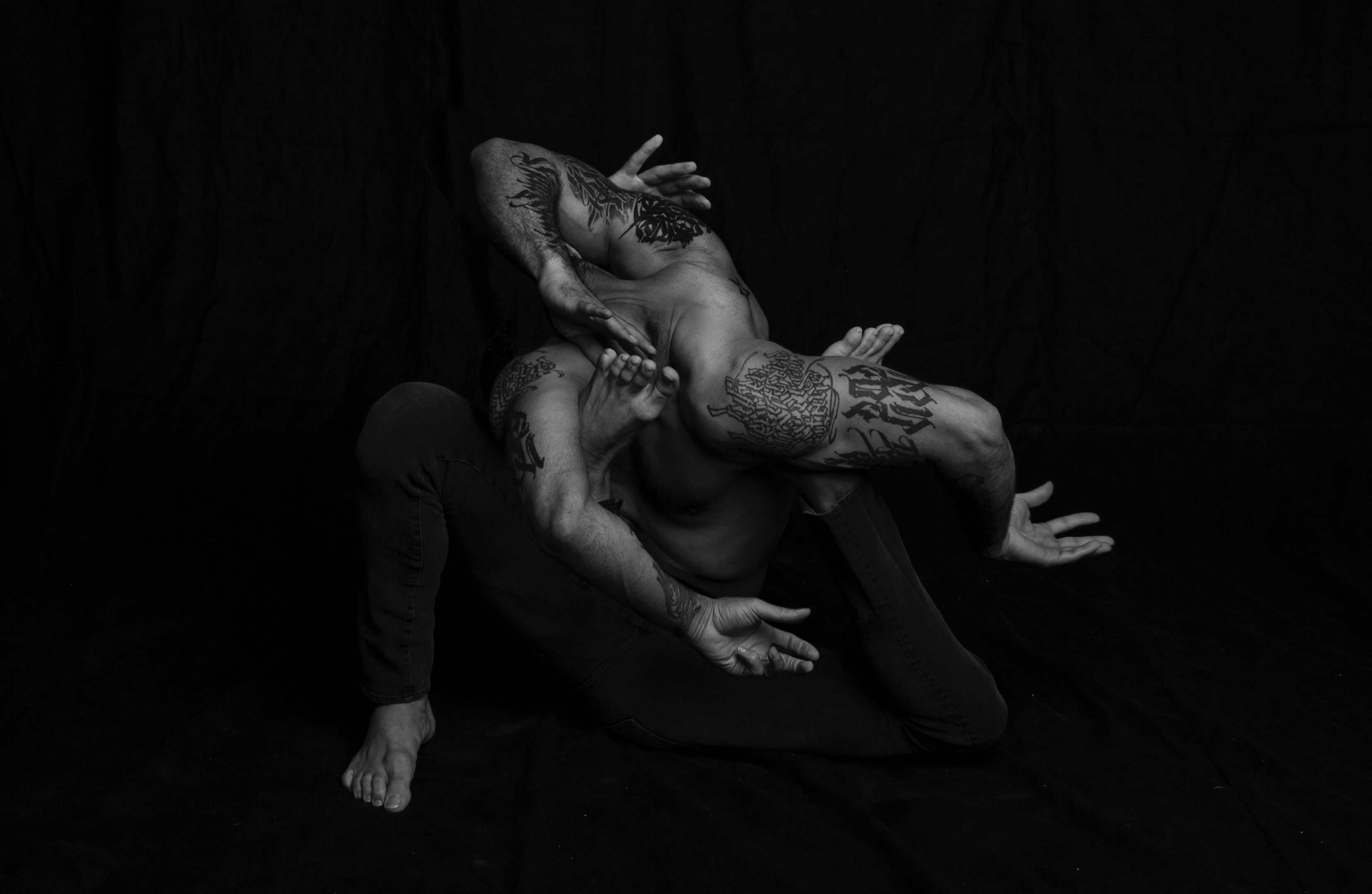 Picture showing a dancer with his arms and legs tied together