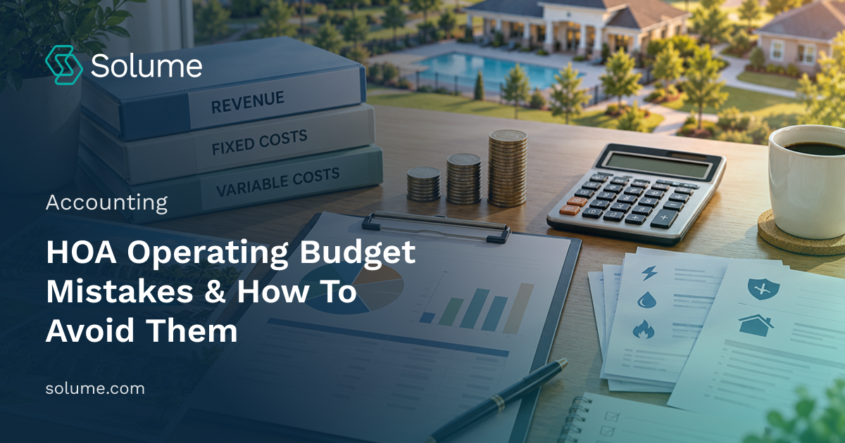 HOA budget planning workspace with revenue, fixed cost, and variable cost binders, financial charts, a calculator, coins, and community property photos on a wooden desk.