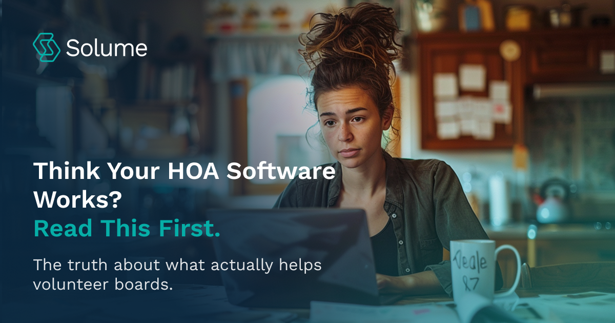 A young woman sits at a kitchen table, focused on her laptop, surrounded by paperwork and a coffee mug. The text on the image reads: “Think Your HOA Software Works? Read This First. The truth about what actually helps volunteer boards.” The scene reflects the everyday reality of volunteer HOA board members managing community tasks from home.