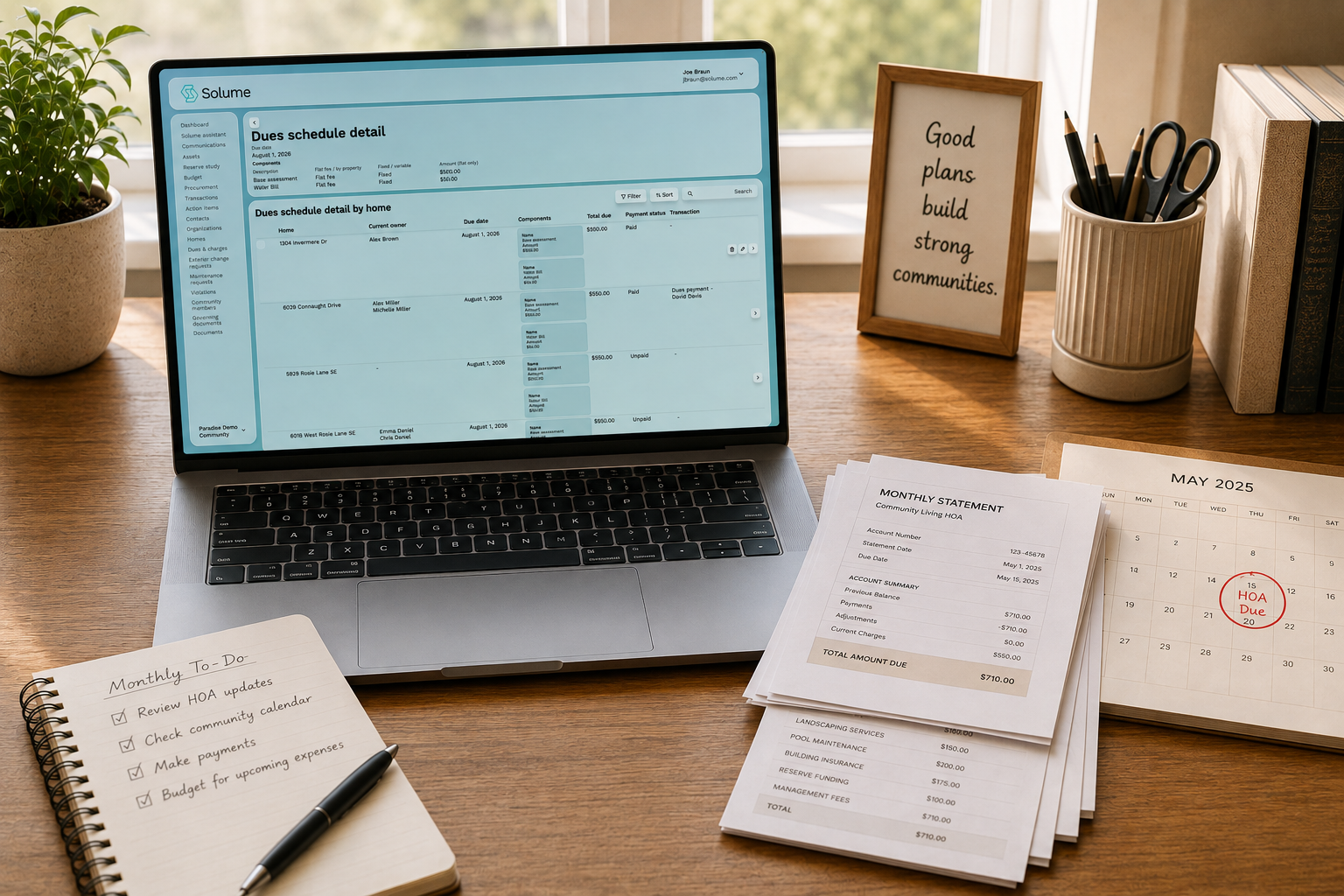A clean home-office setup featuring the Solume HOA dues dashboard, organized payment documents, and a calendar, illustrating simple and structured community financial management.