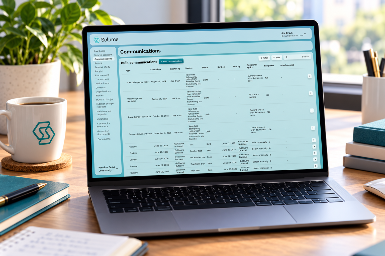 Laptop displaying Solume’s HOA management software communications dashboard with bulk messages, recipient details, and communication statuses on a clean office desk.
