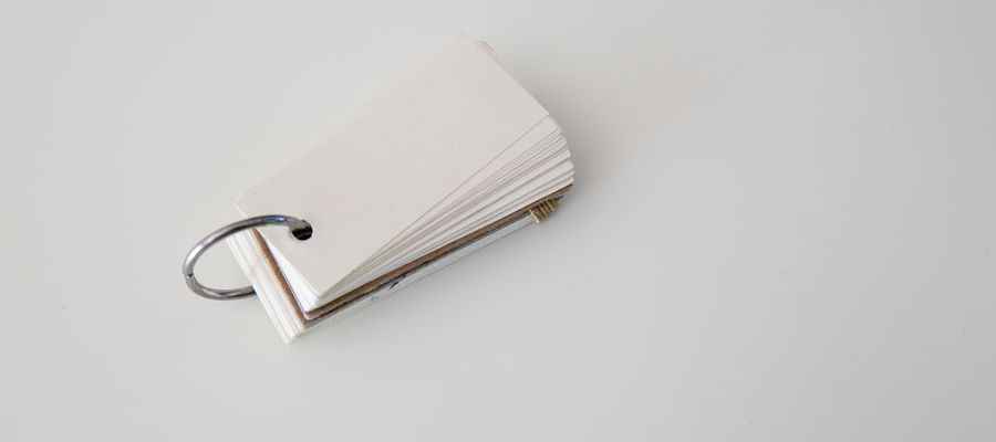Blank study cards held together by a metal ring on a white surface.