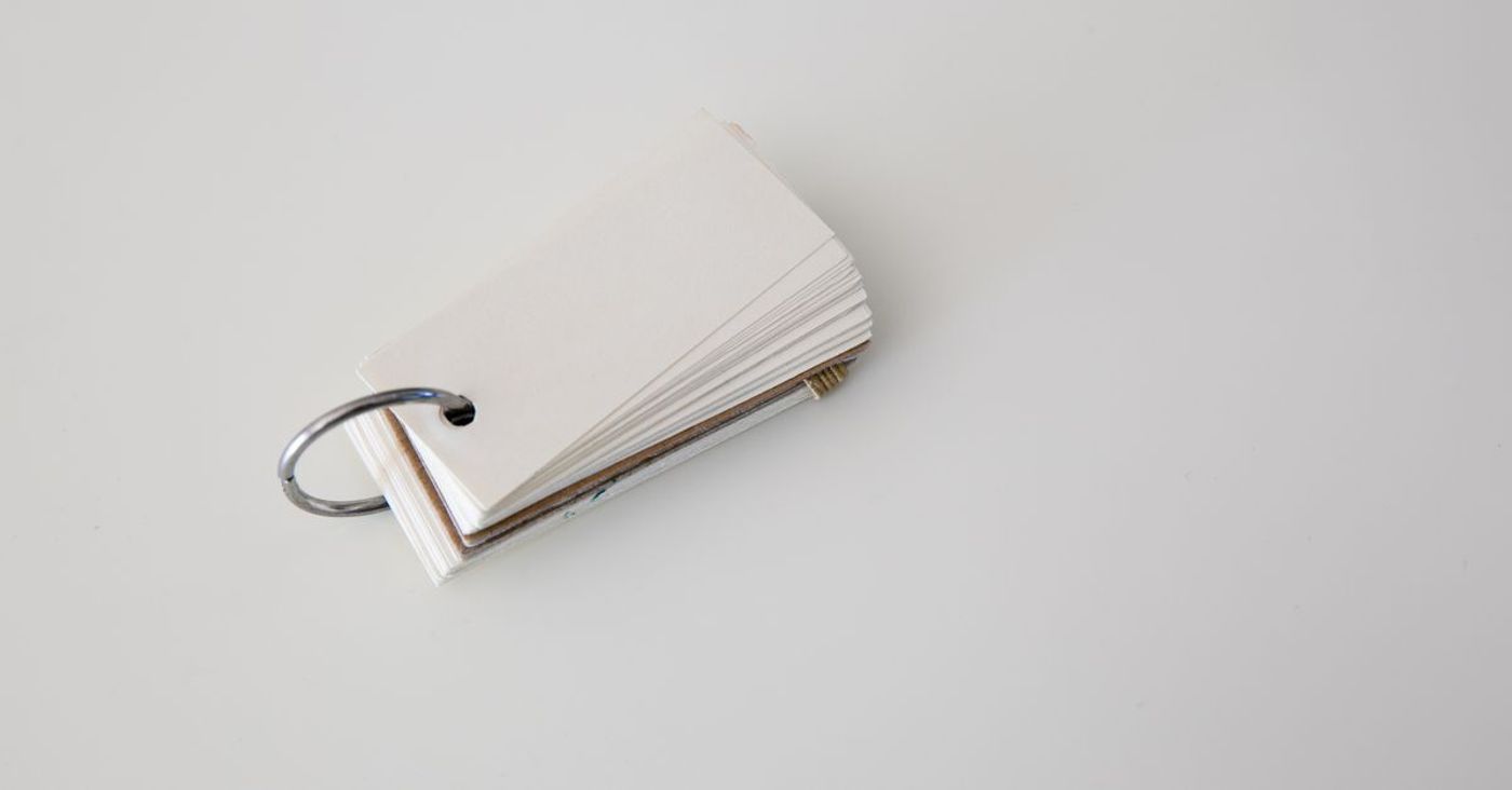 Blank study cards held together by a metal ring on a white surface.