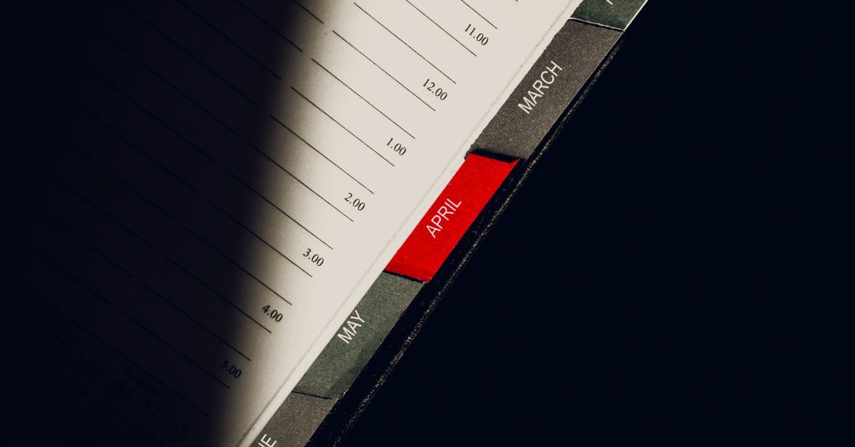Monthly divider tabs in an open planner.