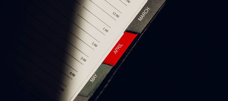 Monthly divider tabs in an open planner.
