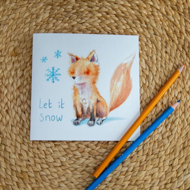 Let it Snow fox Christmas card beside watercolour pens