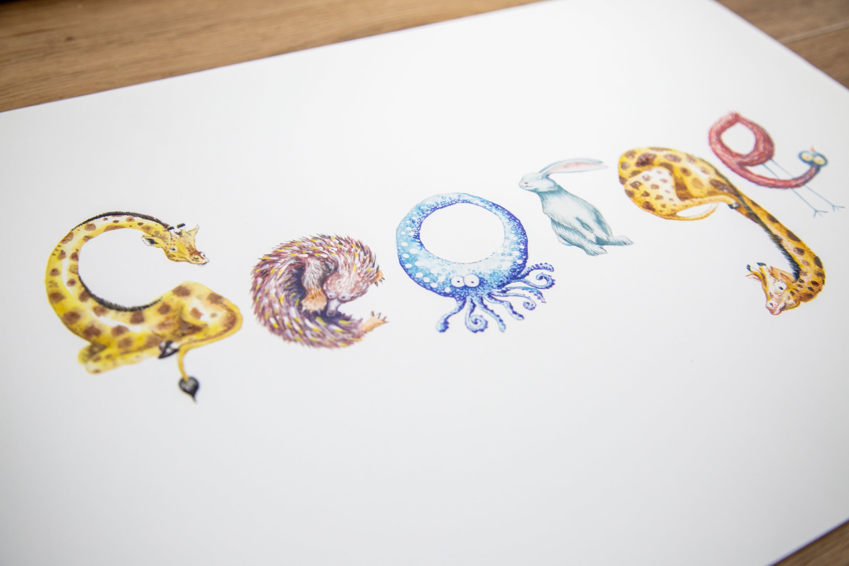 Personalised animal name print spelling George, with each letter drawn as an animal