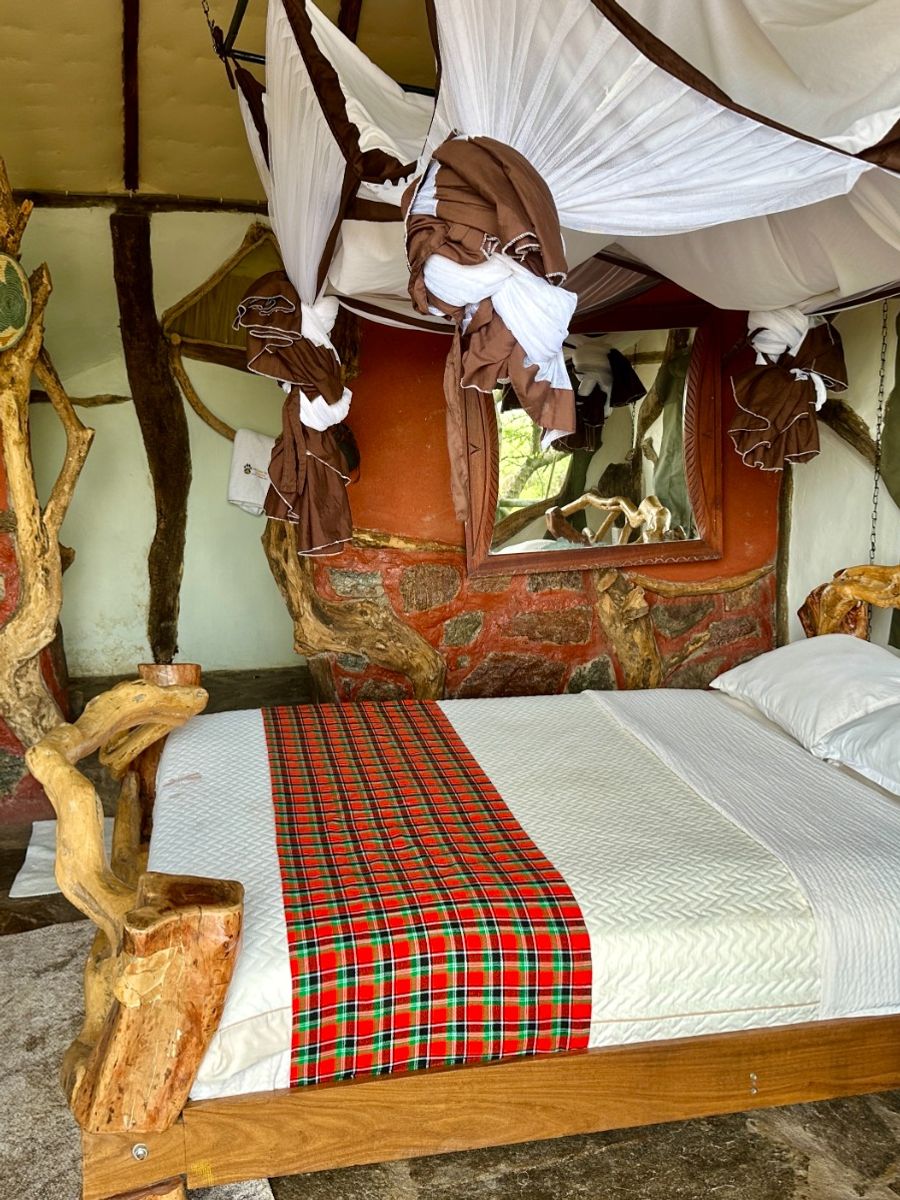 Open-front safari tent beneath the tree canopy