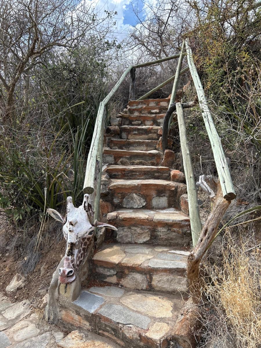 Giraffe trail sculpture along stone staircase