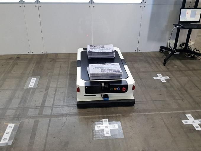 AGV operating over floor QR codes used for position correction.