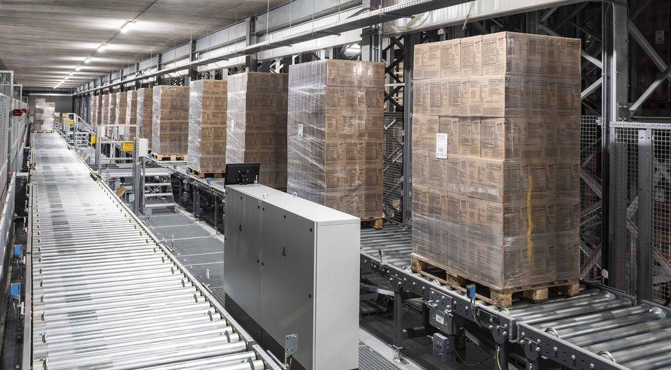 Pallets moving through an automated warehouse conveyor system