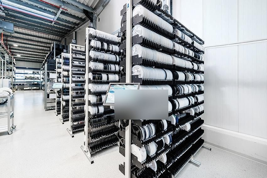 SMT reel storage area organized for controlled buffer inventory and line-side replenishment