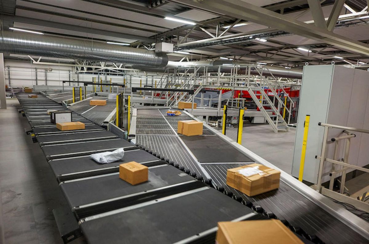 Automated conveyors and sorting equipment moving cartons toward shipping