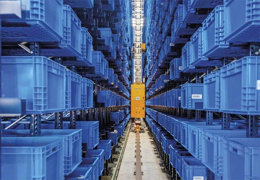 Automated storage and retrieval system operating between rows of blue warehouse totes