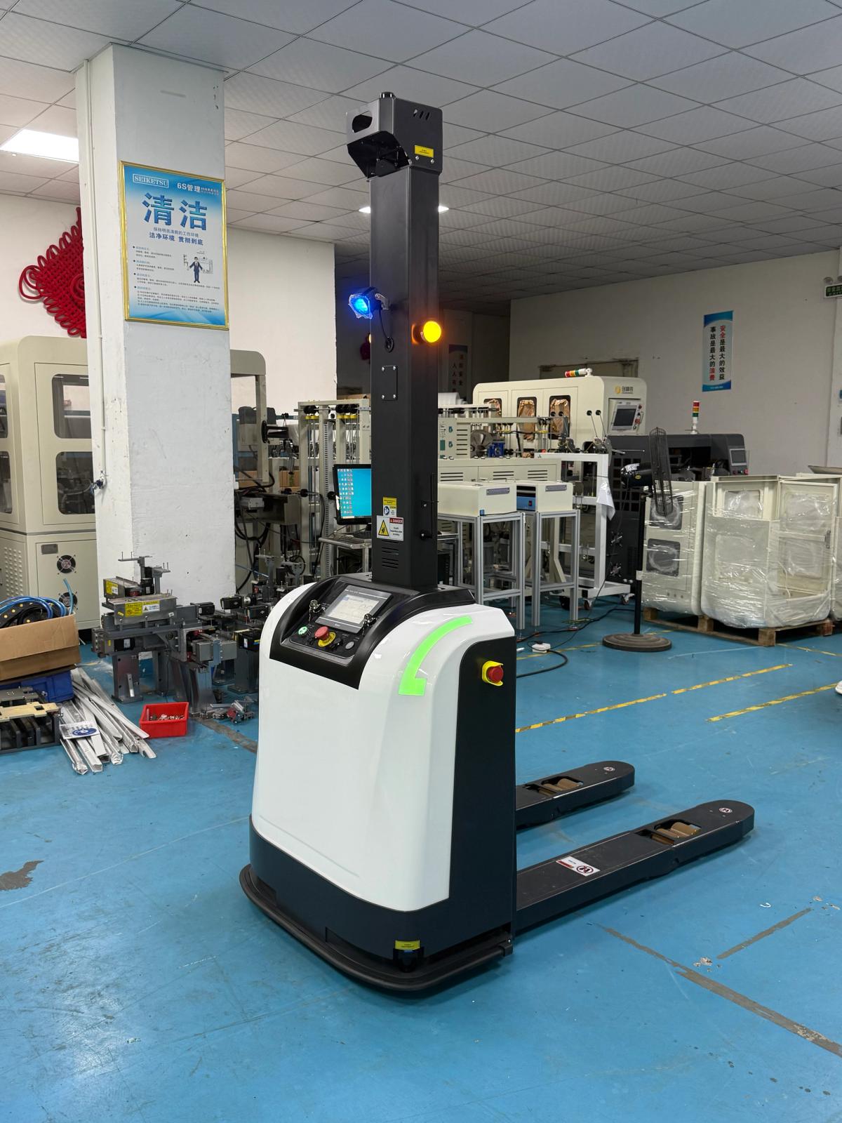 Autonomous pallet transport forklift in a factory environment, with a low-lift fork platform, navigation sensors, and safety devices