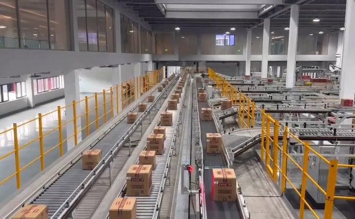 Warehouse conveyor sortation lines moving cartons through an automated fulfillment area
