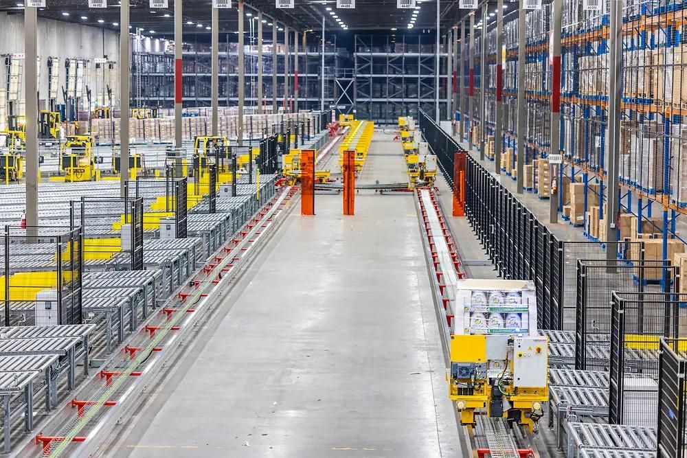 Automated warehouse with conveyors, rack storage, and material handling equipment