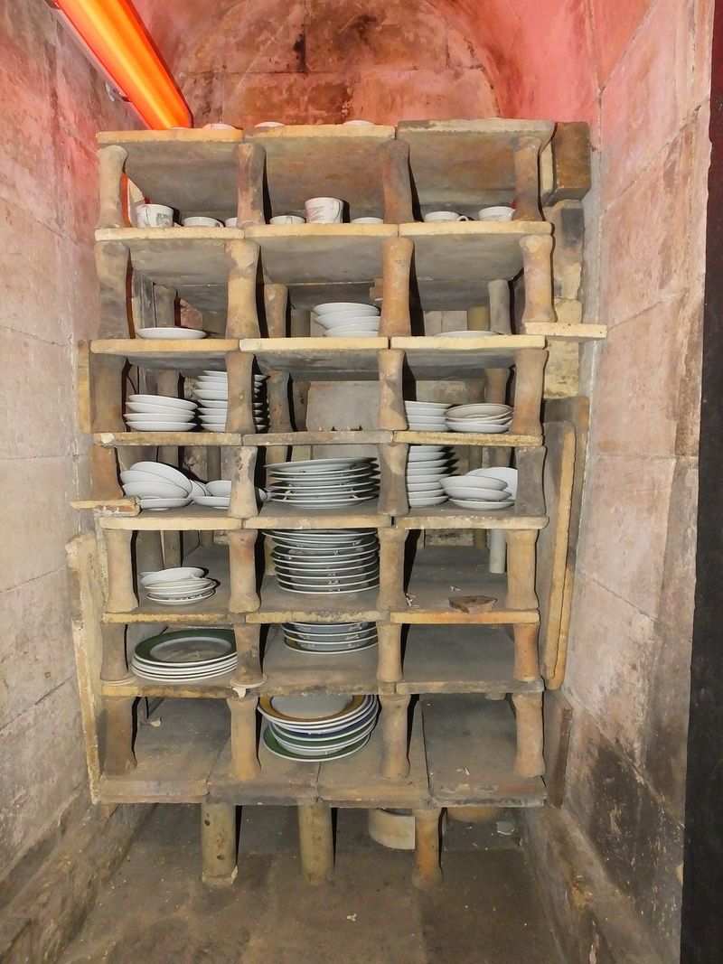 Estante de placas refratárias com pratos dentro de um forno