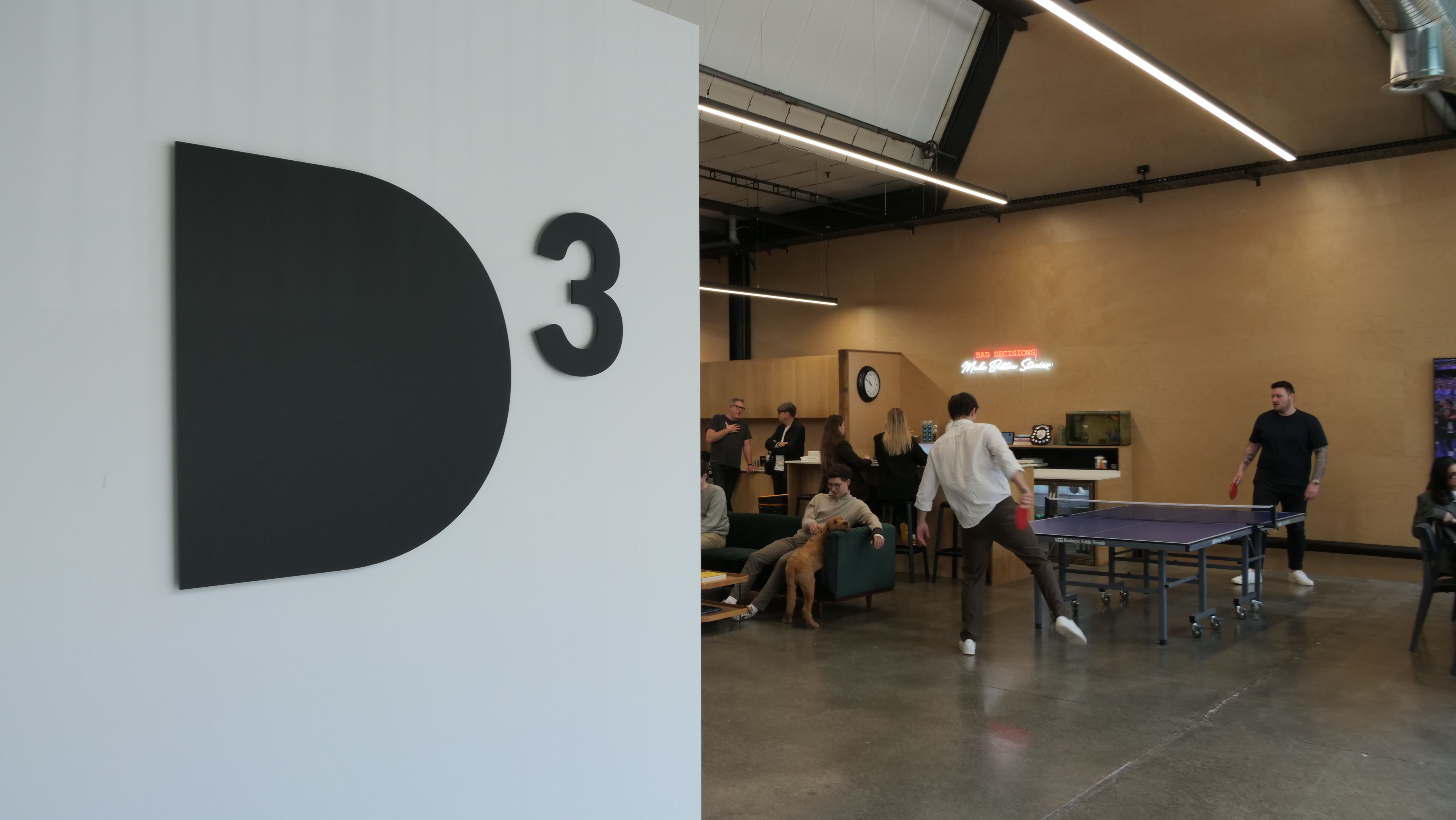 Staff playing table tennis at D3 office