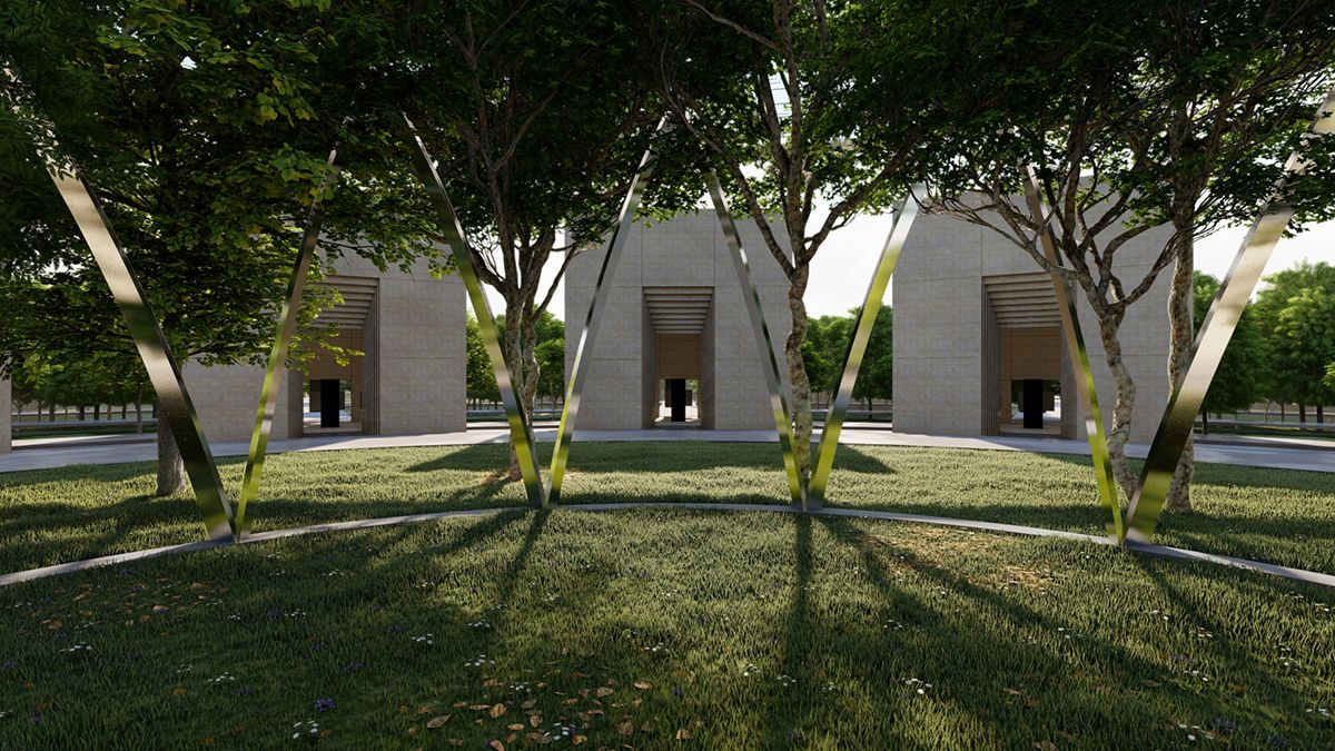 A large metallic frame shaped like a crown in the middle of a grassy area surrounded by trees