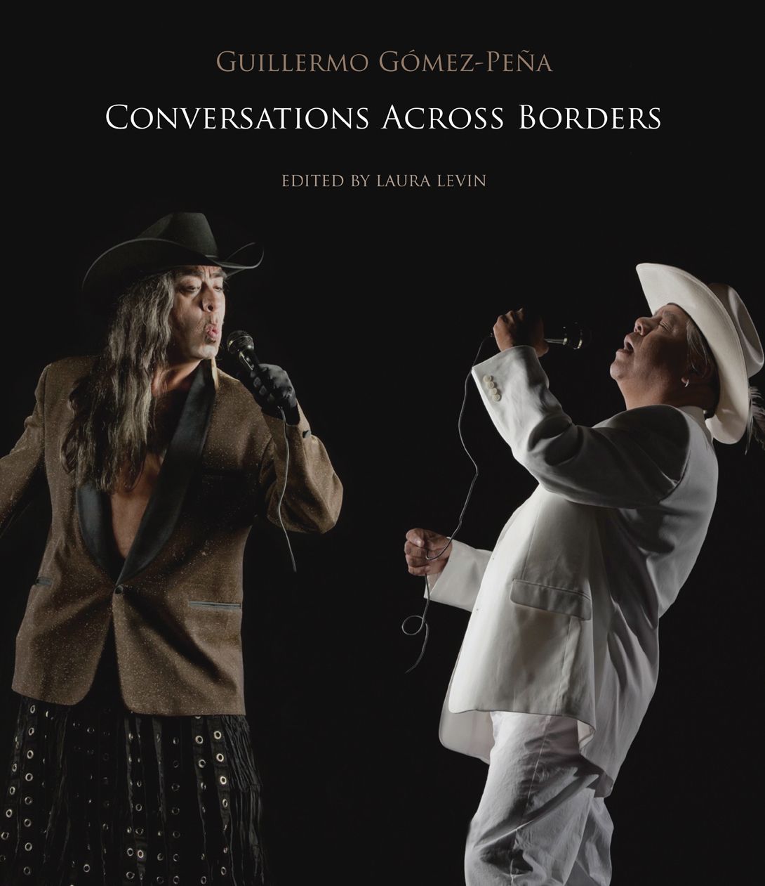 Black book cover with two singers holding microphones. GGP on left side in black and brown. White suited person on right.