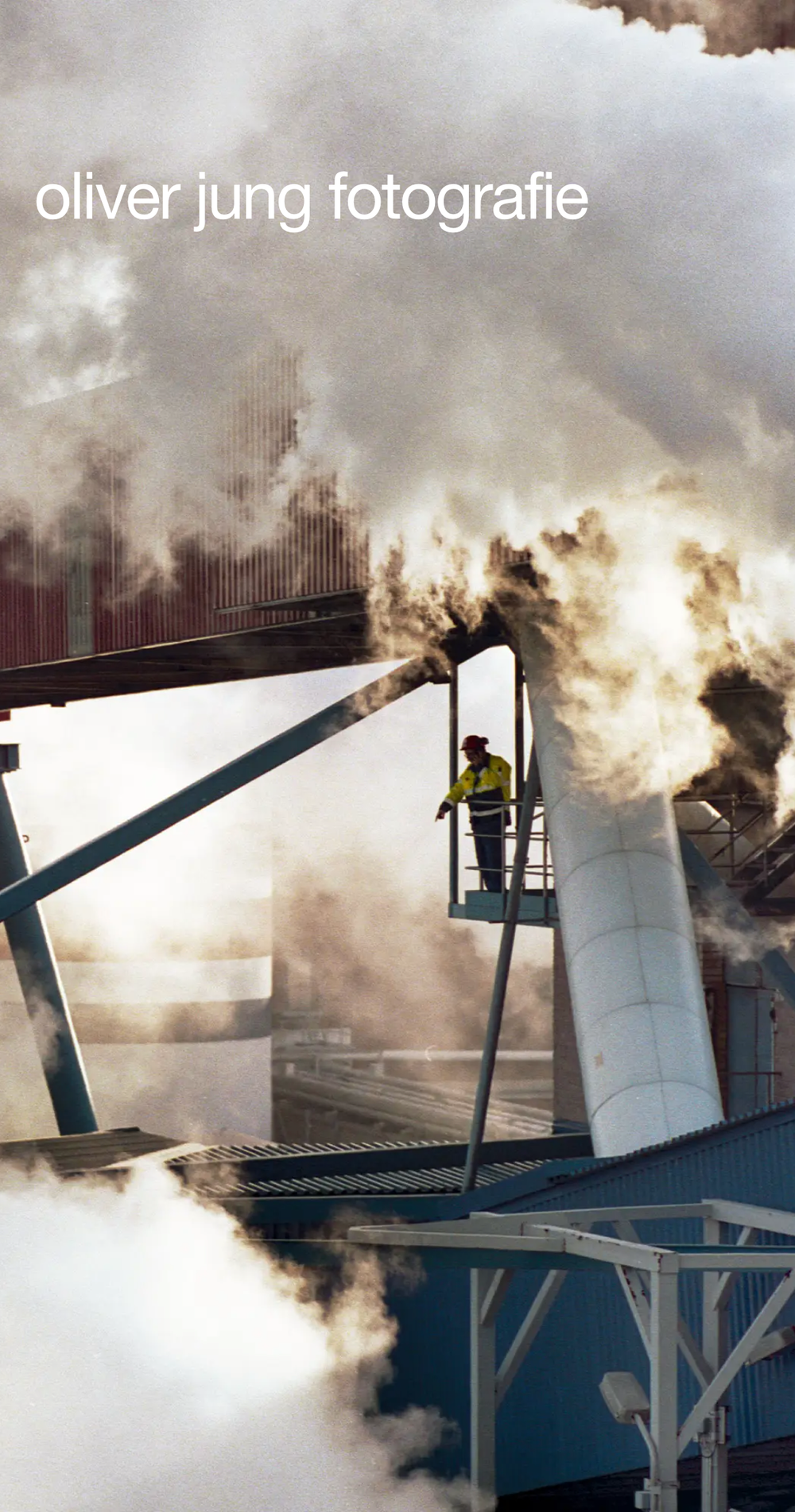 Screenshot from the mobile website showing oliver jung fotografie and a picture of an industrial facility with lots of smoke