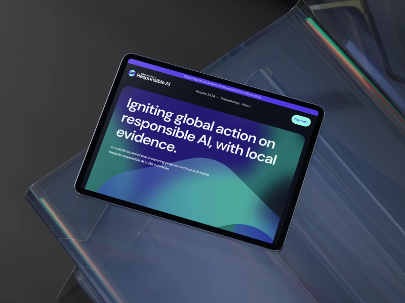 A tablet with a screenshot of the GIRAI website homepage